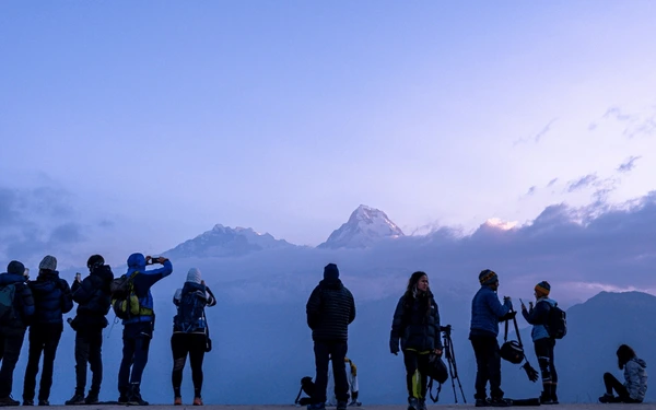 people waiting for sunrise at poonhill